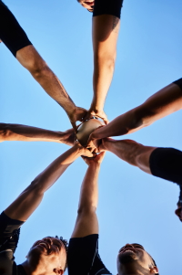 Cropped shot of a handsome group of sportsmen holding a rugby ball together before playing rugby